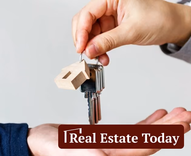 Article thumbnail showing a hand holding keychain with house-shaped keyring above another open hand with text Real Estate Today.