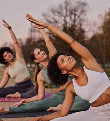 Group of women stretching together outdoors