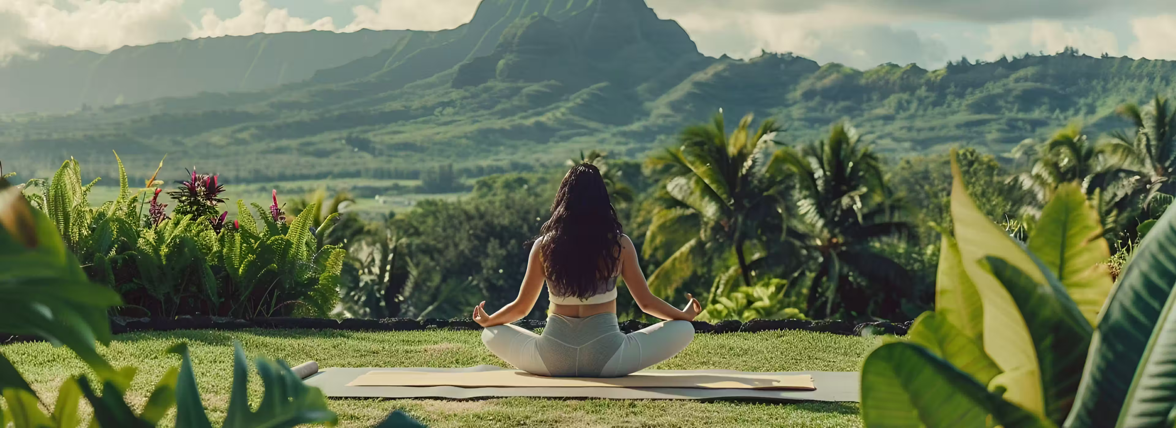 Woman doing yoga on the beach at sunset