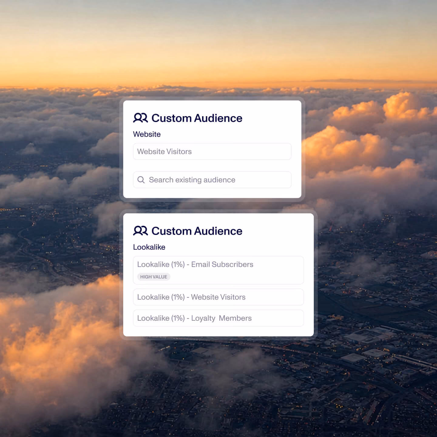 User interface screen showing two sections titled Custom Audience with user group options. The first section is labeled Website with a field for Website Visitors and a search bar for existing audiences. The second section is labeled Lookalike with three options: Lookalike (1%) - Email Subscribers marked High Value, Lookalike (1%) - Website Visitors, and Lookalike (1%) - Loyalty Members. The UI is displayed over a background of aerial cityscape with clouds and a sunset sky.