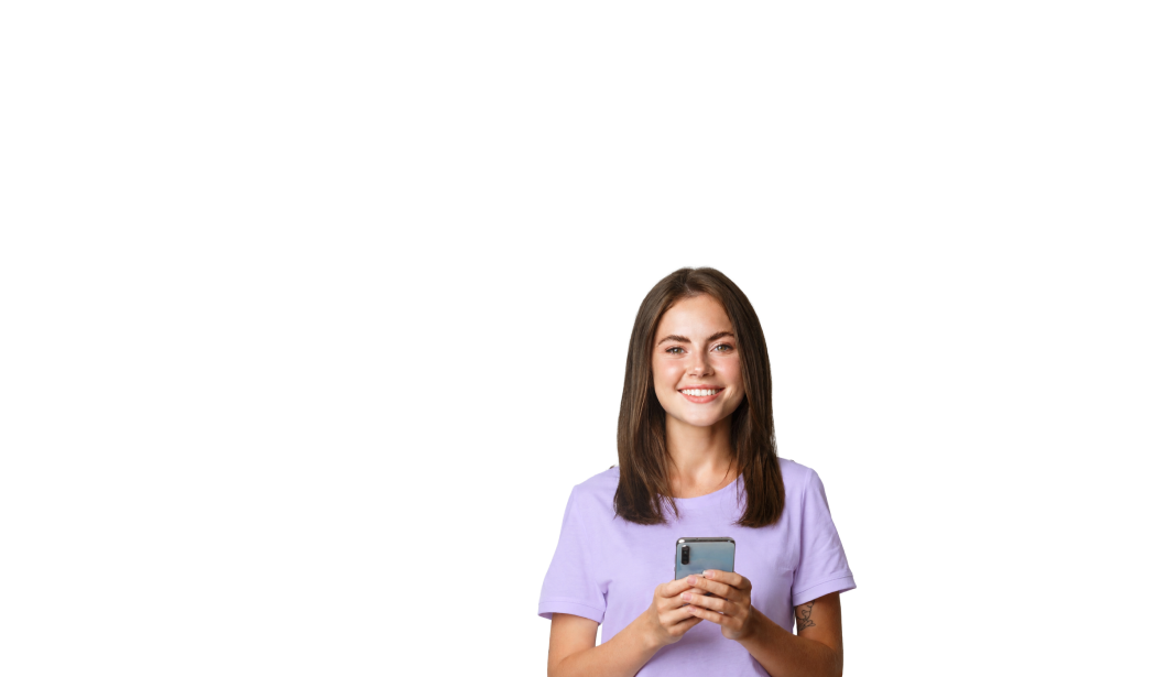 Smiling young woman in a purple shirt holding a smartphone with both hands.
