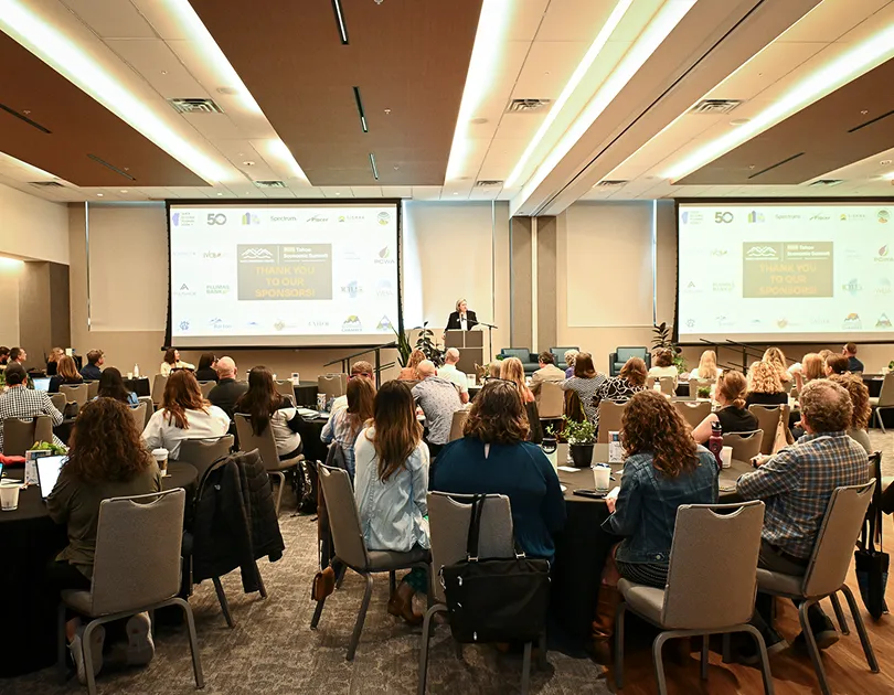 An auditorium full of people receiving insights from a speaker