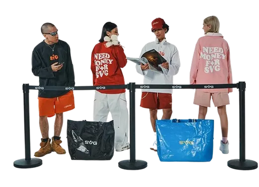 Four people in branded streetwear waiting behind a queue barrier