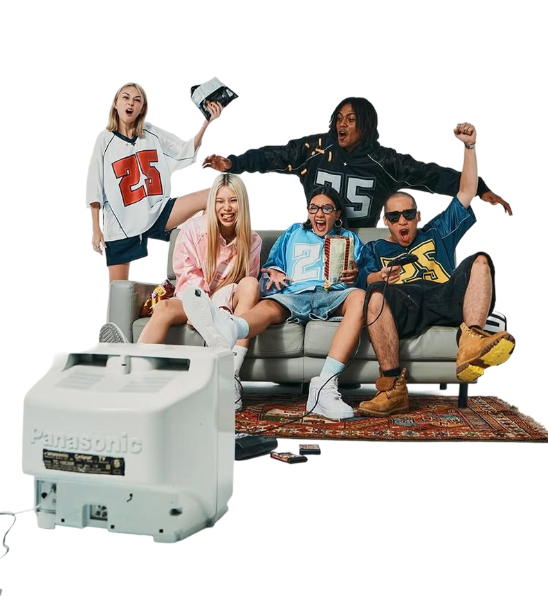 Group of friends cheering on a sofa in front of a retro TV