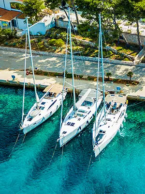 Yacht moored stern-to at a Mediterranean quay