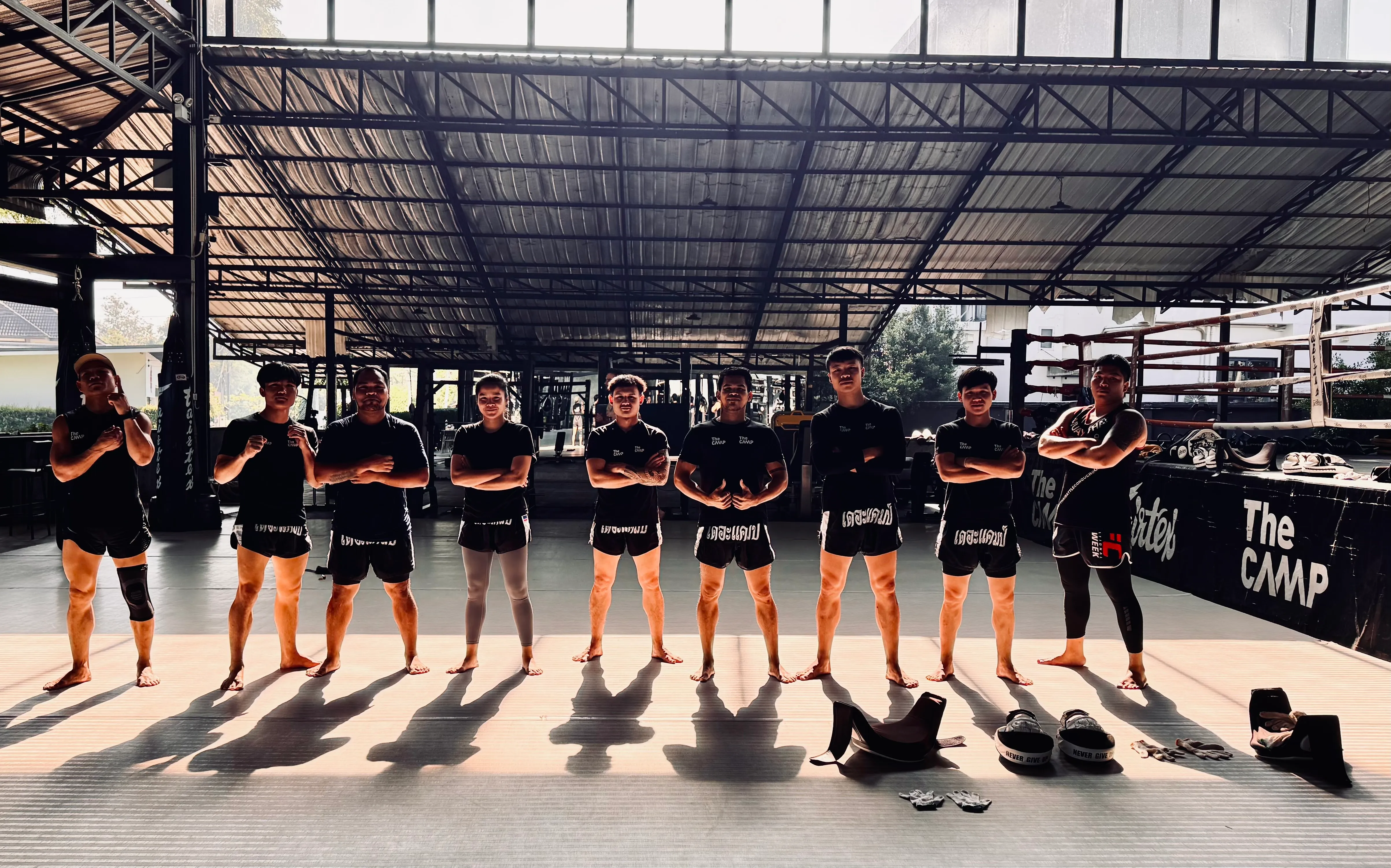 The Camp Muay Thai trainers standing in a line in the gym