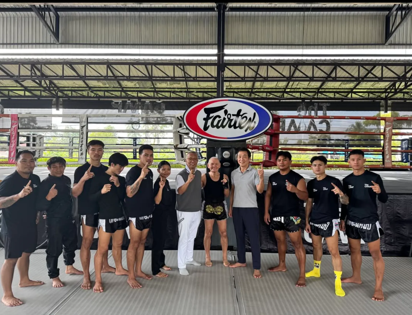 The Camp trainers and visitors gathered beside the boxing ring