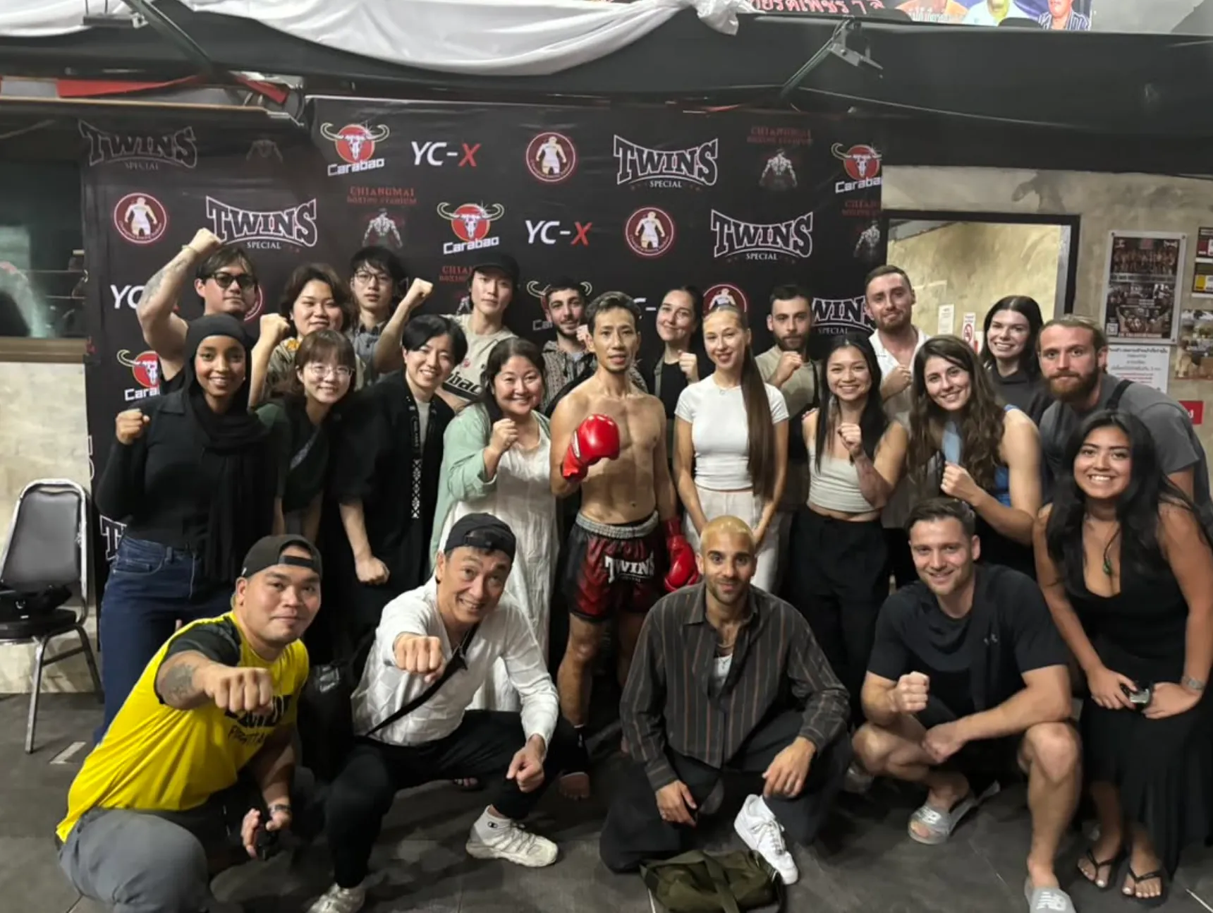 The Camp community gathered around a Muay Thai fighter at the stadium