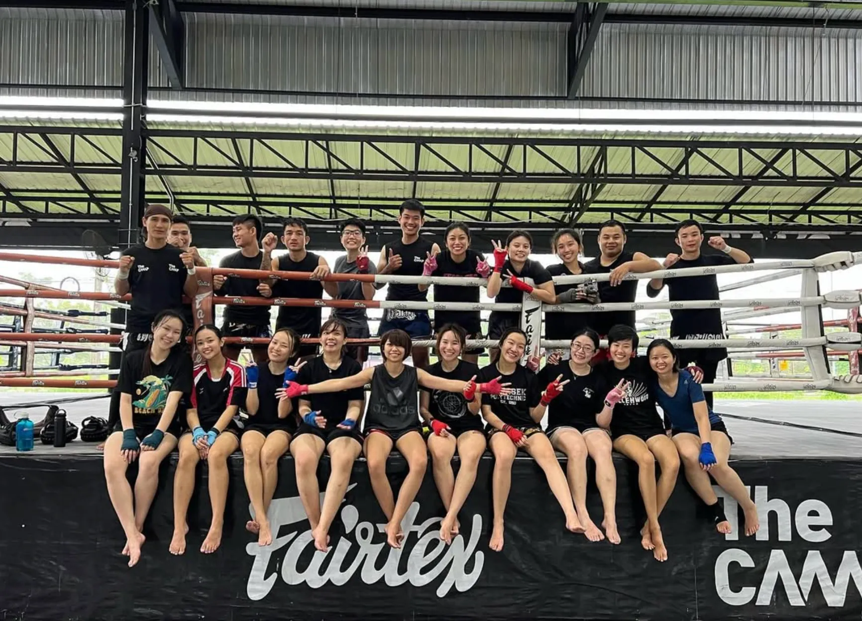 The Camp training group sitting and standing together at the ring