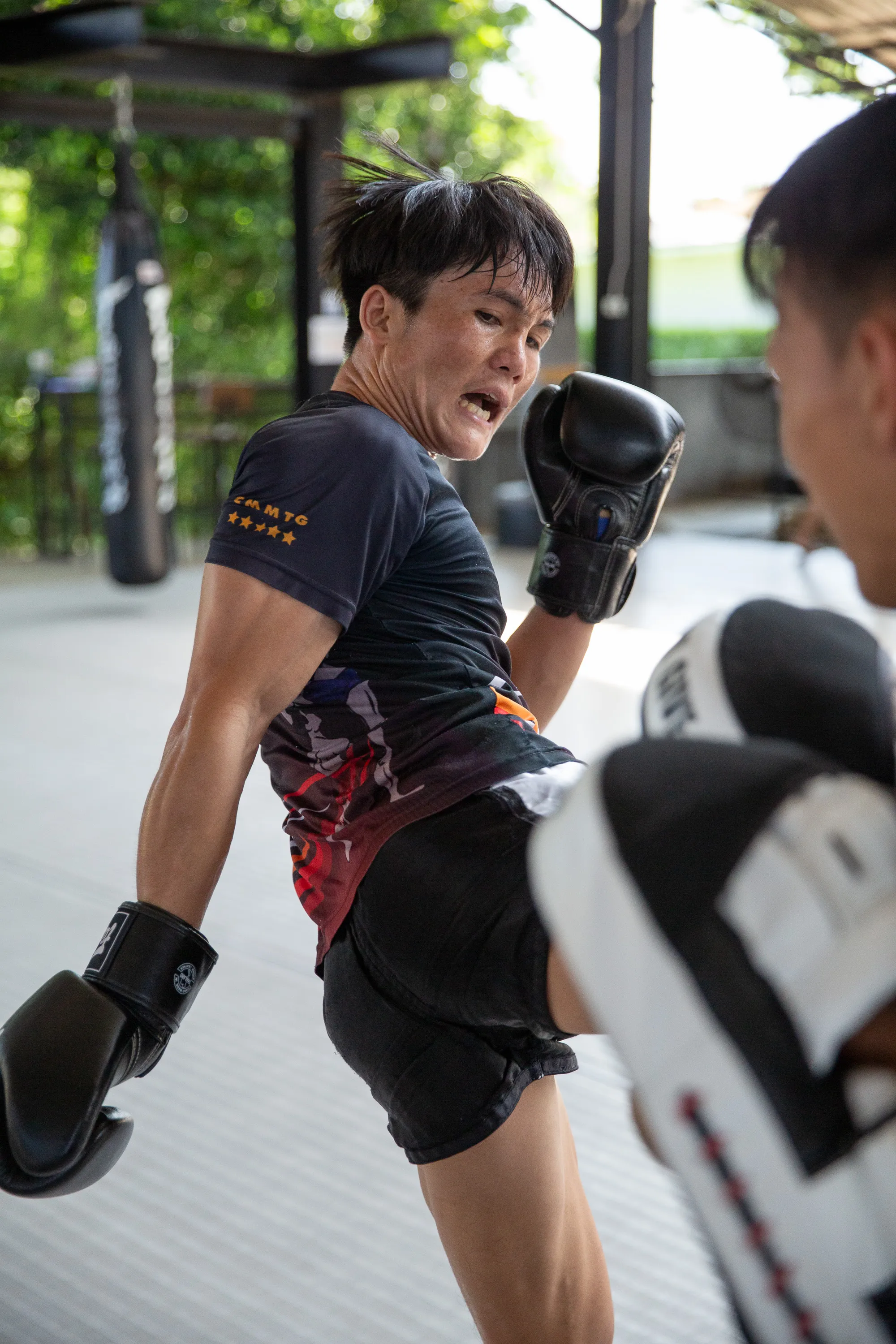 A student practising with her Muay Thai coach