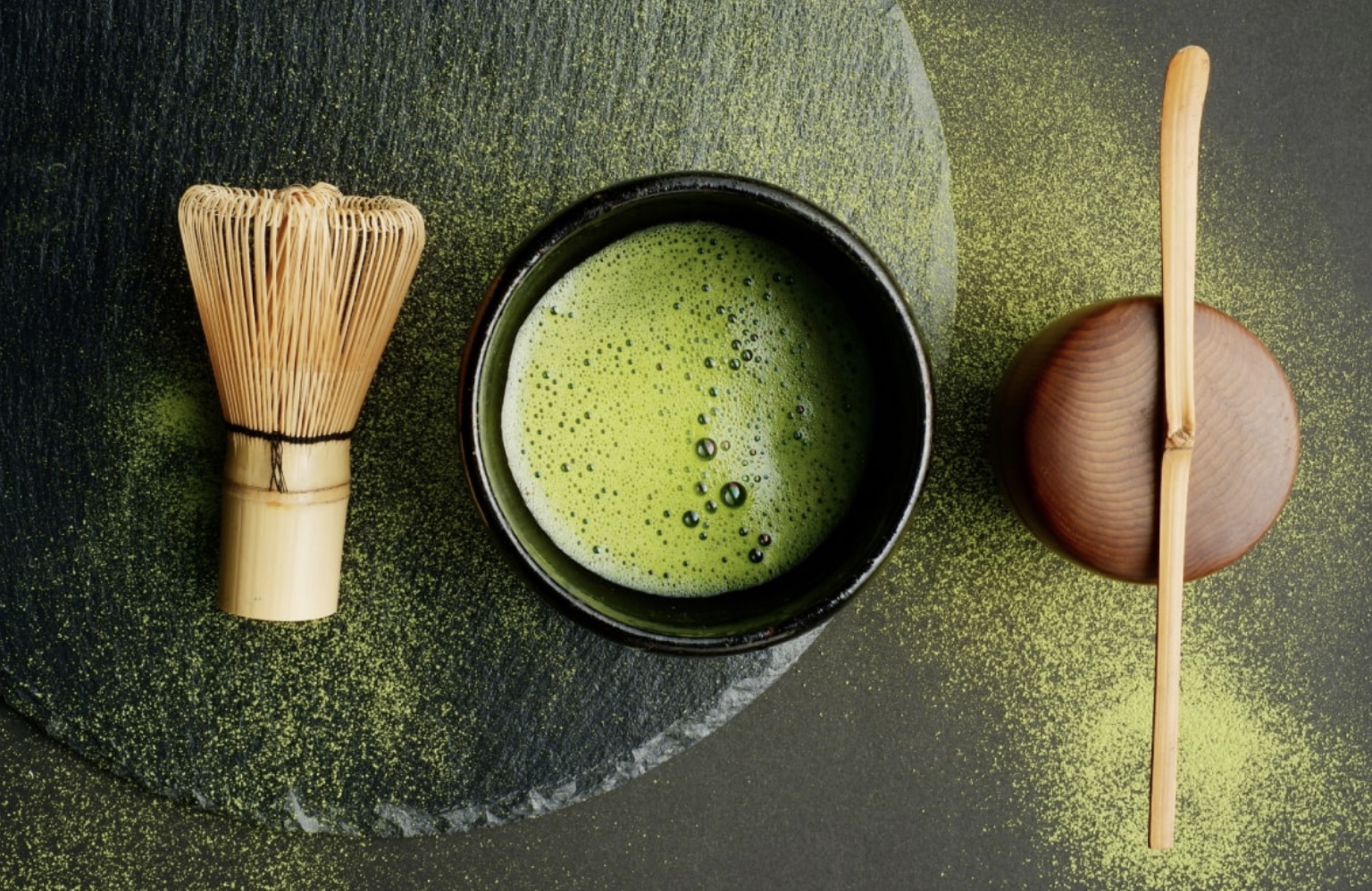 Matcha tea with whisk and tea scoop