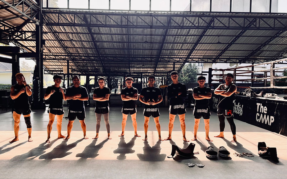 Muay Thai trainees standing together inside The Camp Chiang Mai training facility