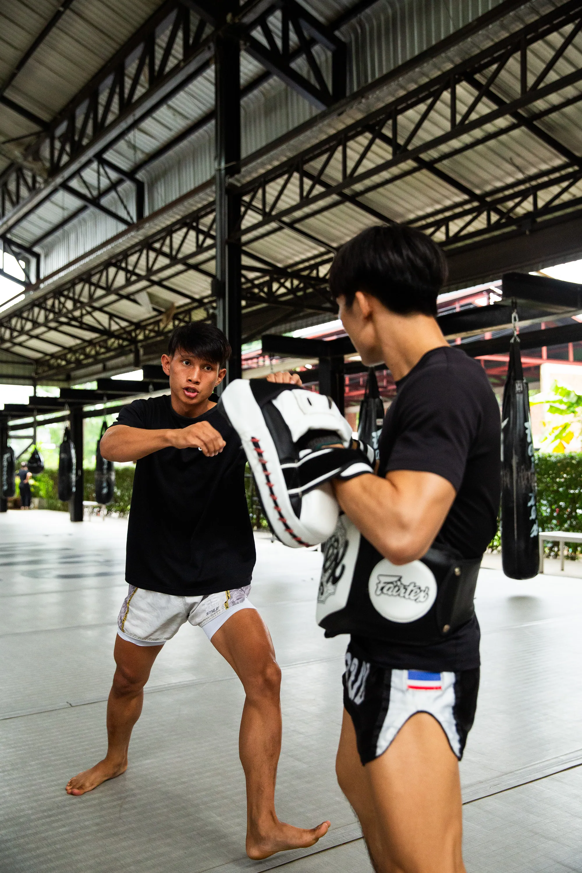 A student listening to a coach beside the ring