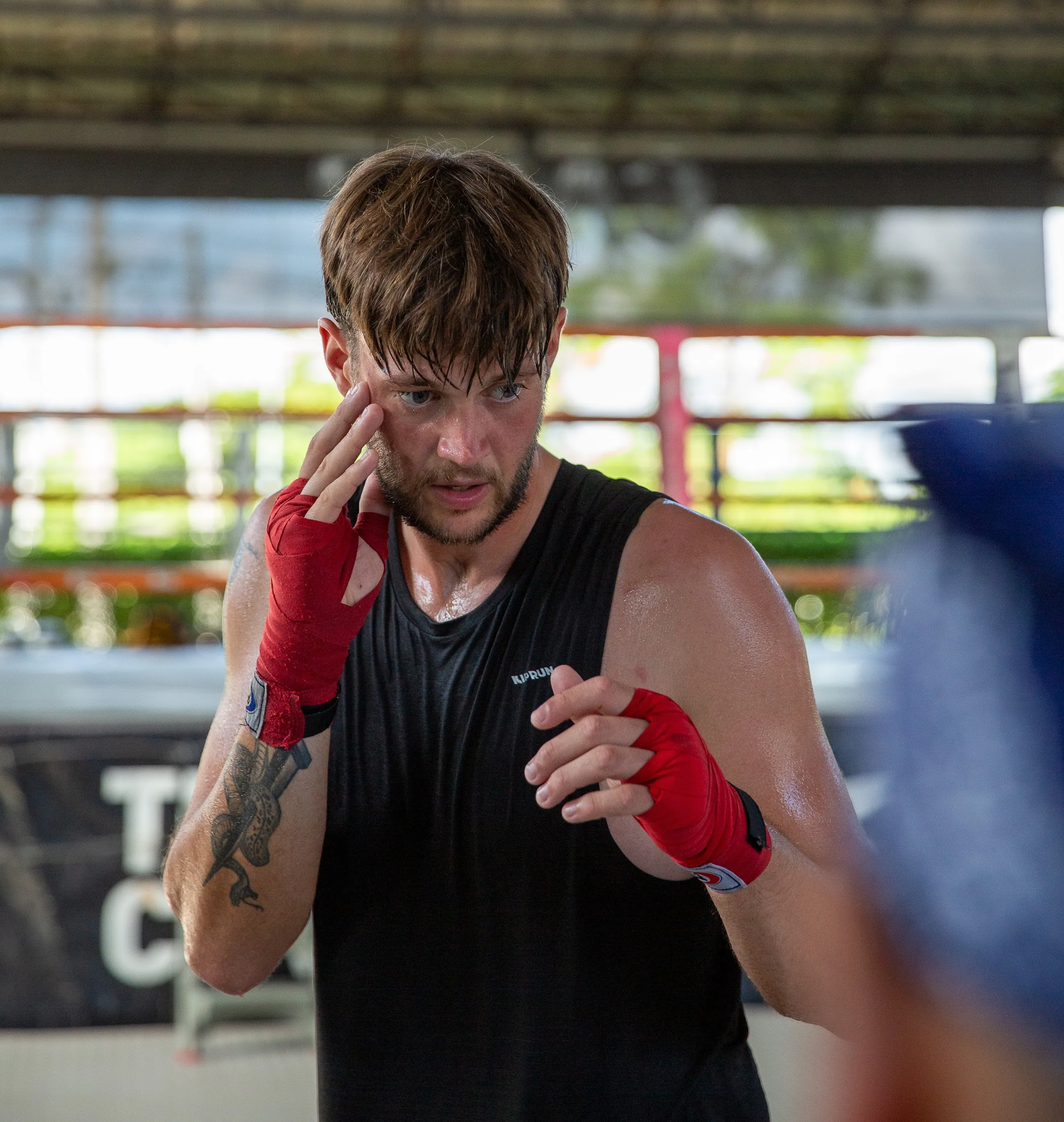 A student practising knees with a trainer
