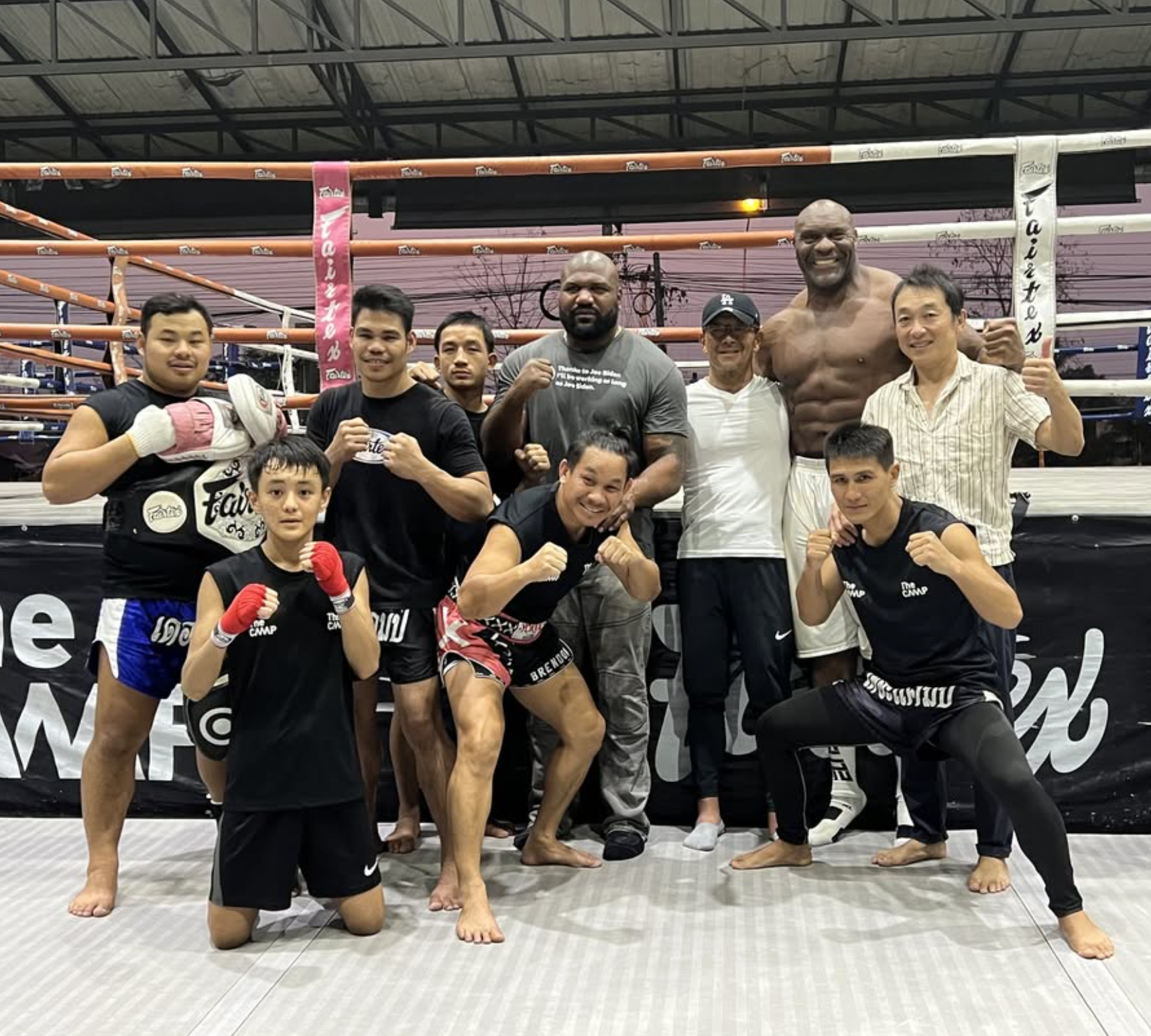 The Camp training community posing together beside the boxing ring