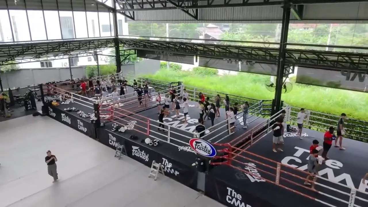 Aerial view of the two Muay Thai rings and training floor at The Camp, Chiang Mai