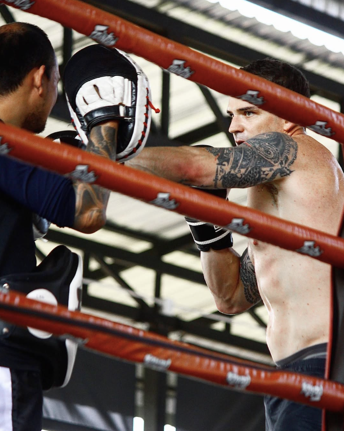 A student practising punches on focus mitts
