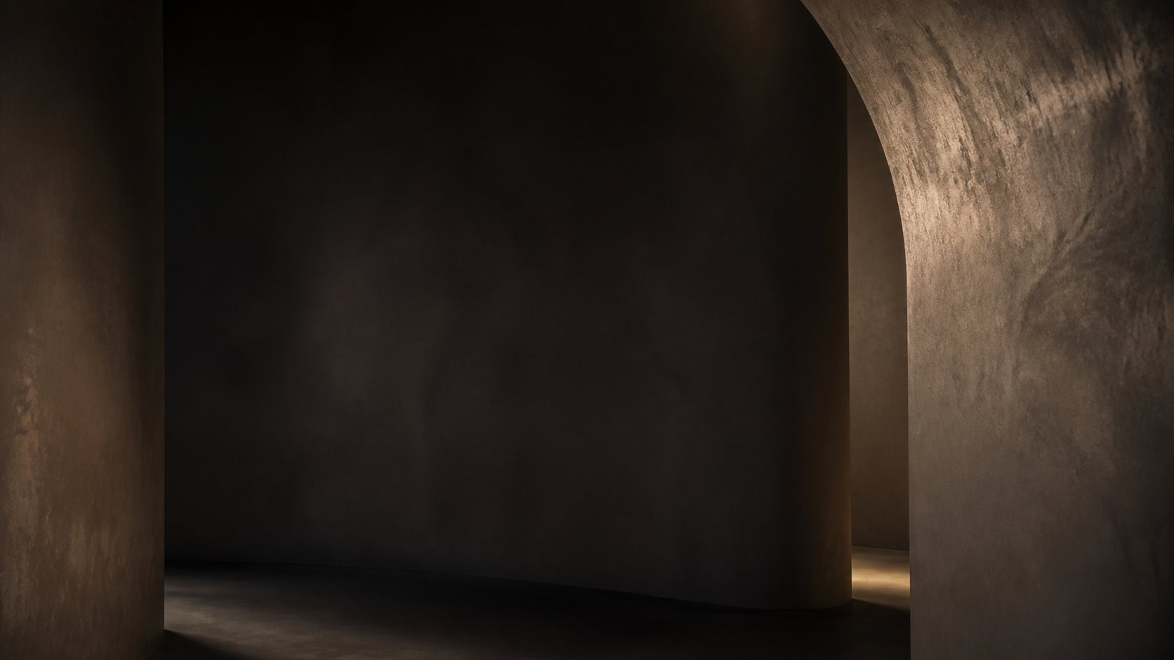 Hand-plastered archways with a polished traditional plaster finish in warm light