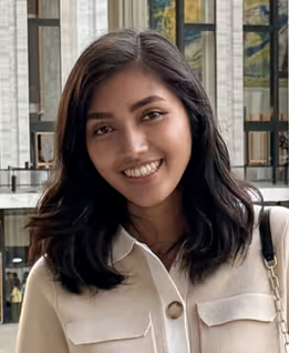 Nadine smiling in front of a bright window