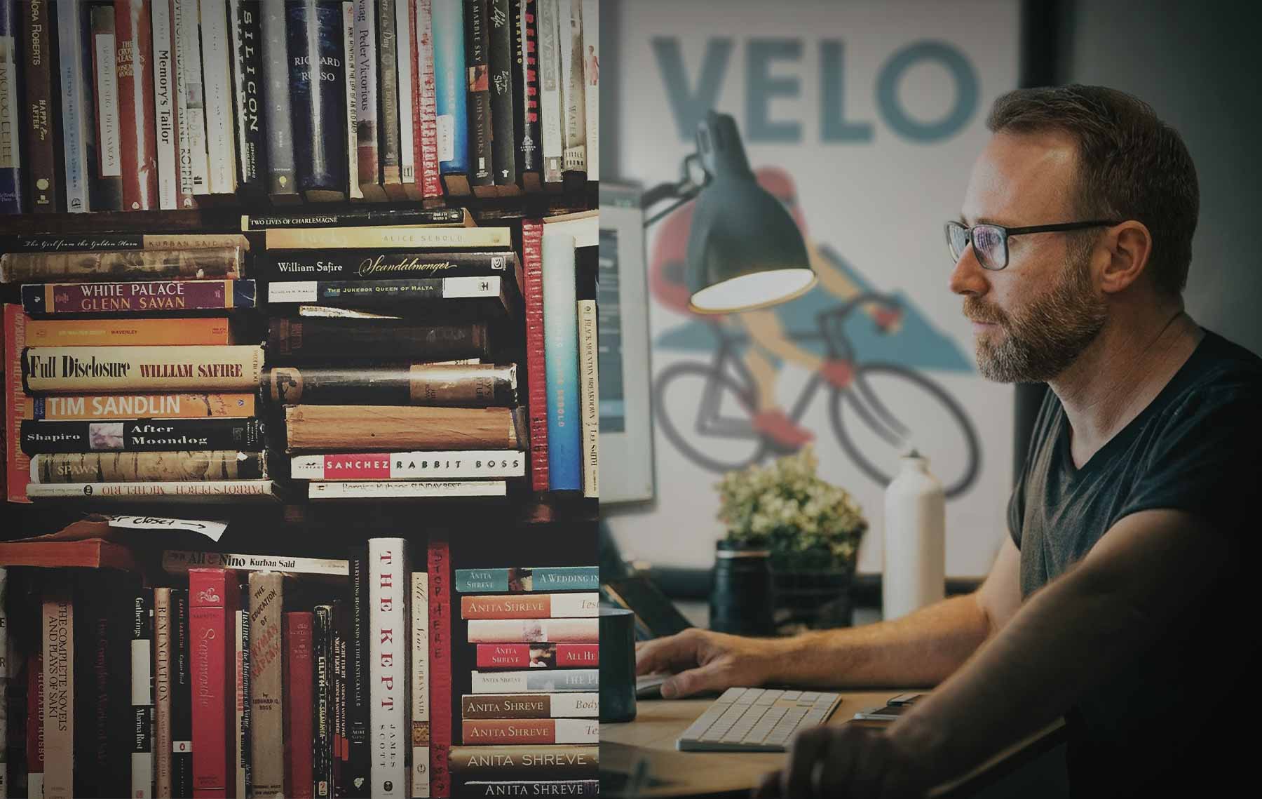 portrait of a graphic designer next to bookshelves