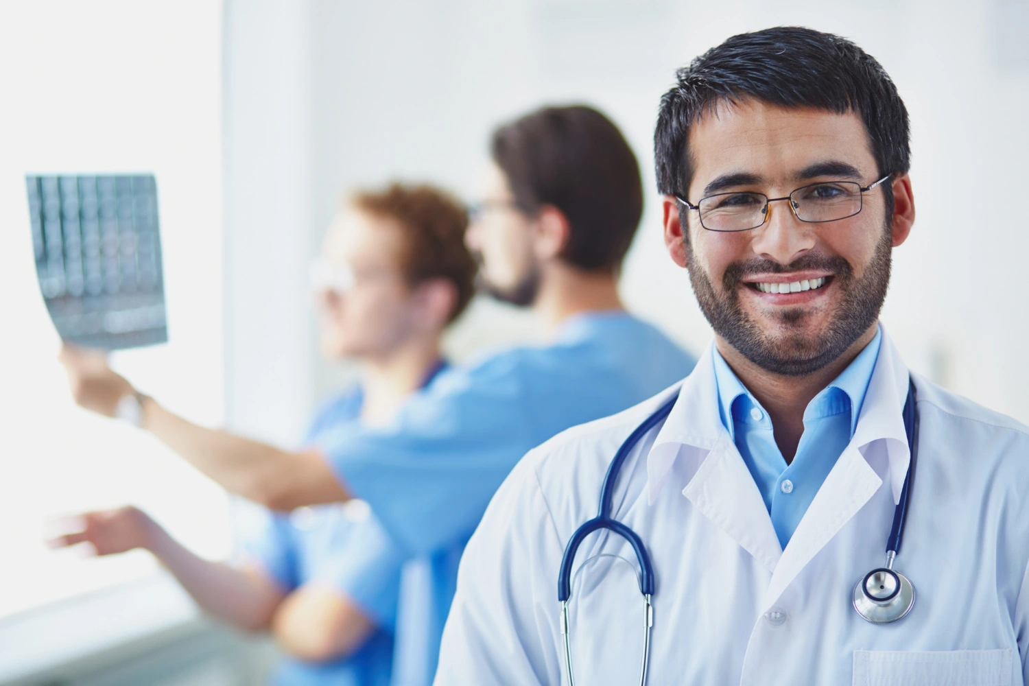 Doctor examining a man's upper arm with a dermatoscope in a clinical setting.