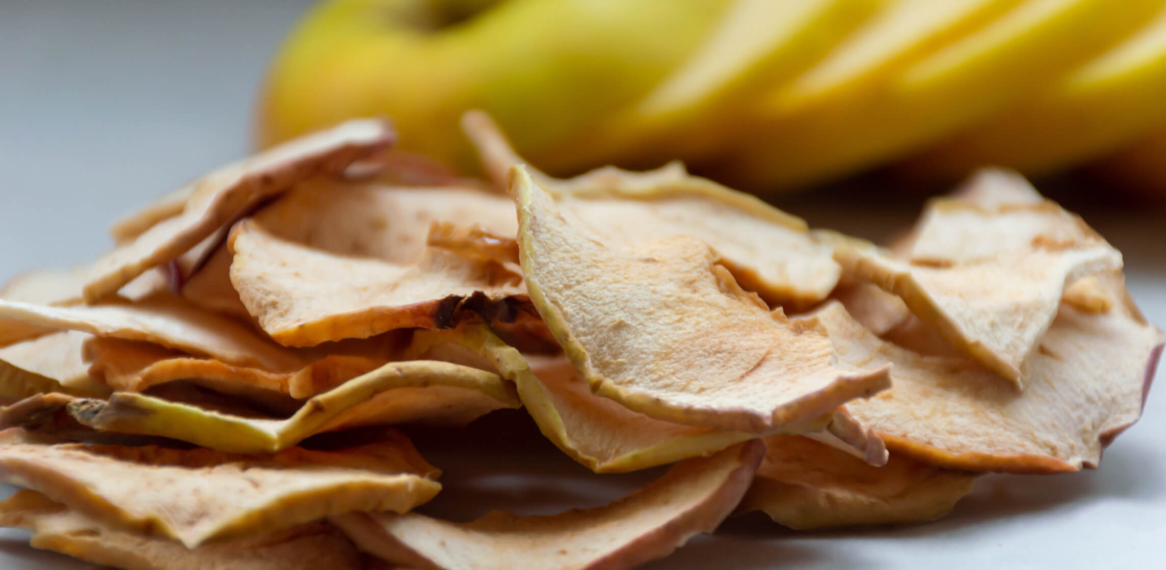 Dried apple chips arranged on a plate, from WISEcode's clean label apple snack ranking