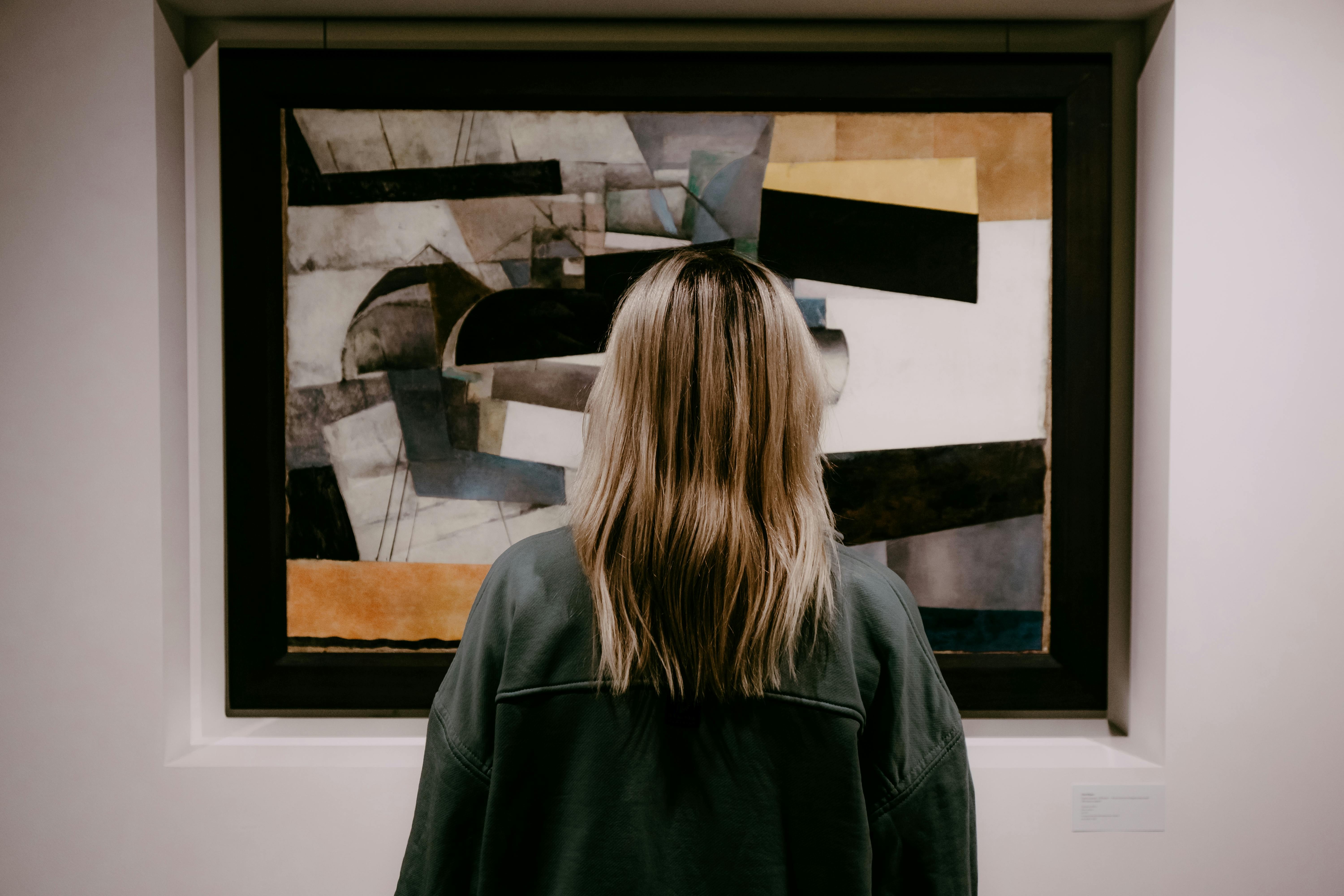 A visitor viewing a work of art in a gallery