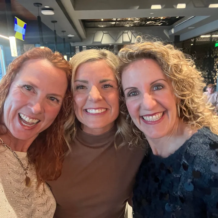 Three community members laughing together
