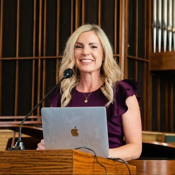 Missy Moss Wright speaking at a podium