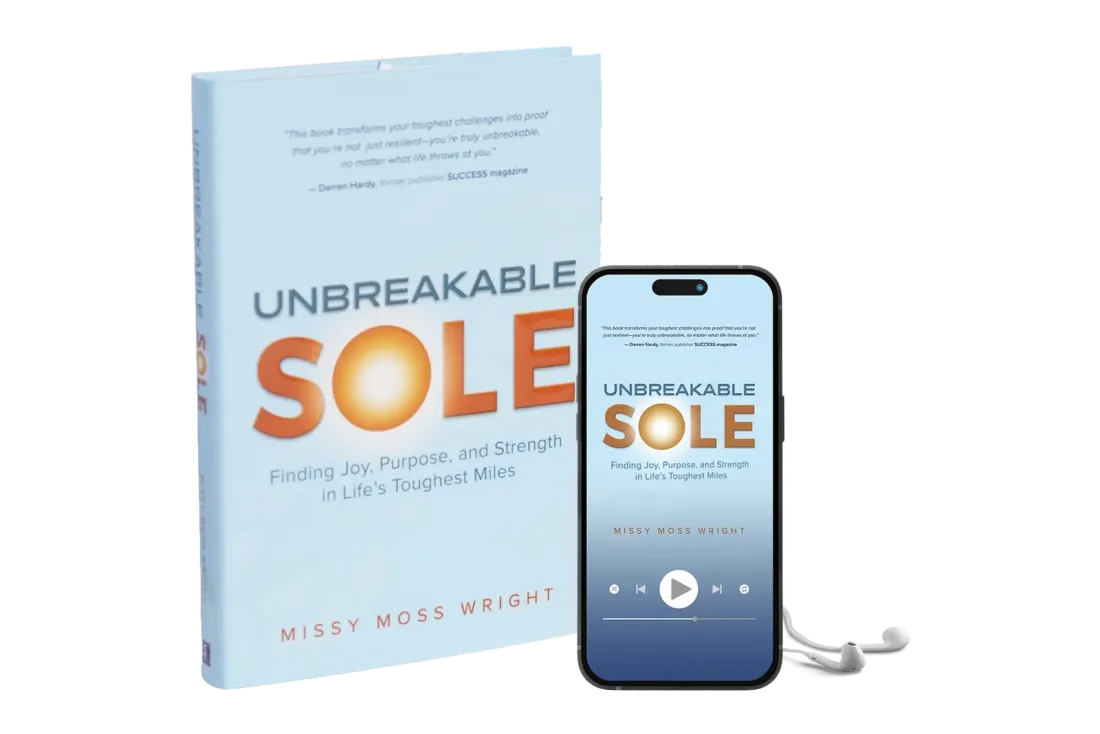 Unbreakable Sole hardcover beside the audiobook playing on a phone
