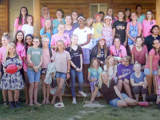 Missy Moss Wright with a large group of teen girls at camp