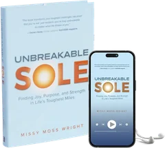 The Unbreakable Sole hardcover beside the audiobook playing on a phone