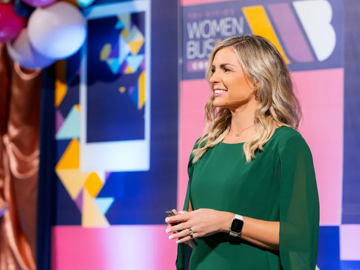 Missy Moss Wright speaking on stage at a women in business conference