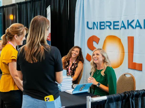 Missy Moss Wright talking with two readers at the Unbreakable Sole booth