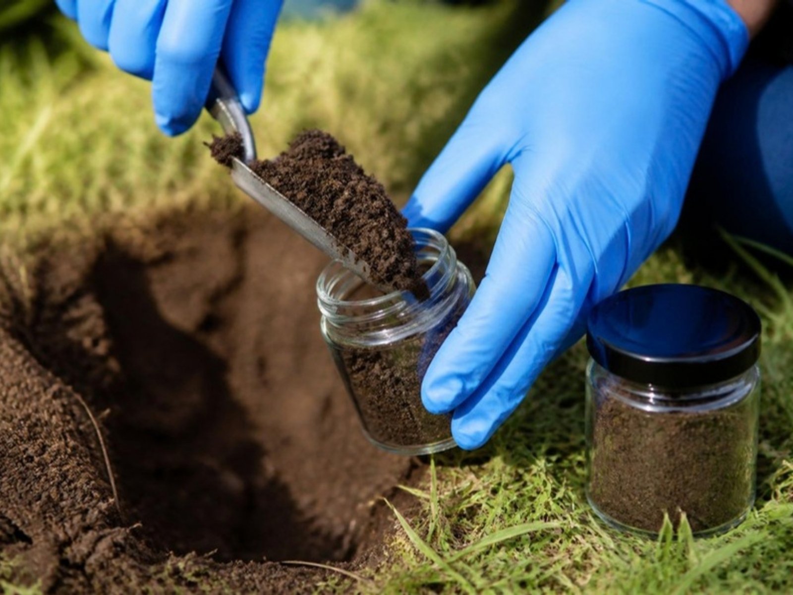 Soil sample being collected from an oil tank excavation