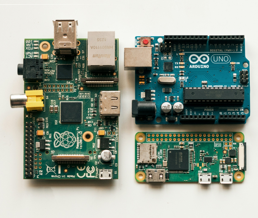 Three different green circuit boards with electronic components, including Raspberry Pi and Arduino UNO.