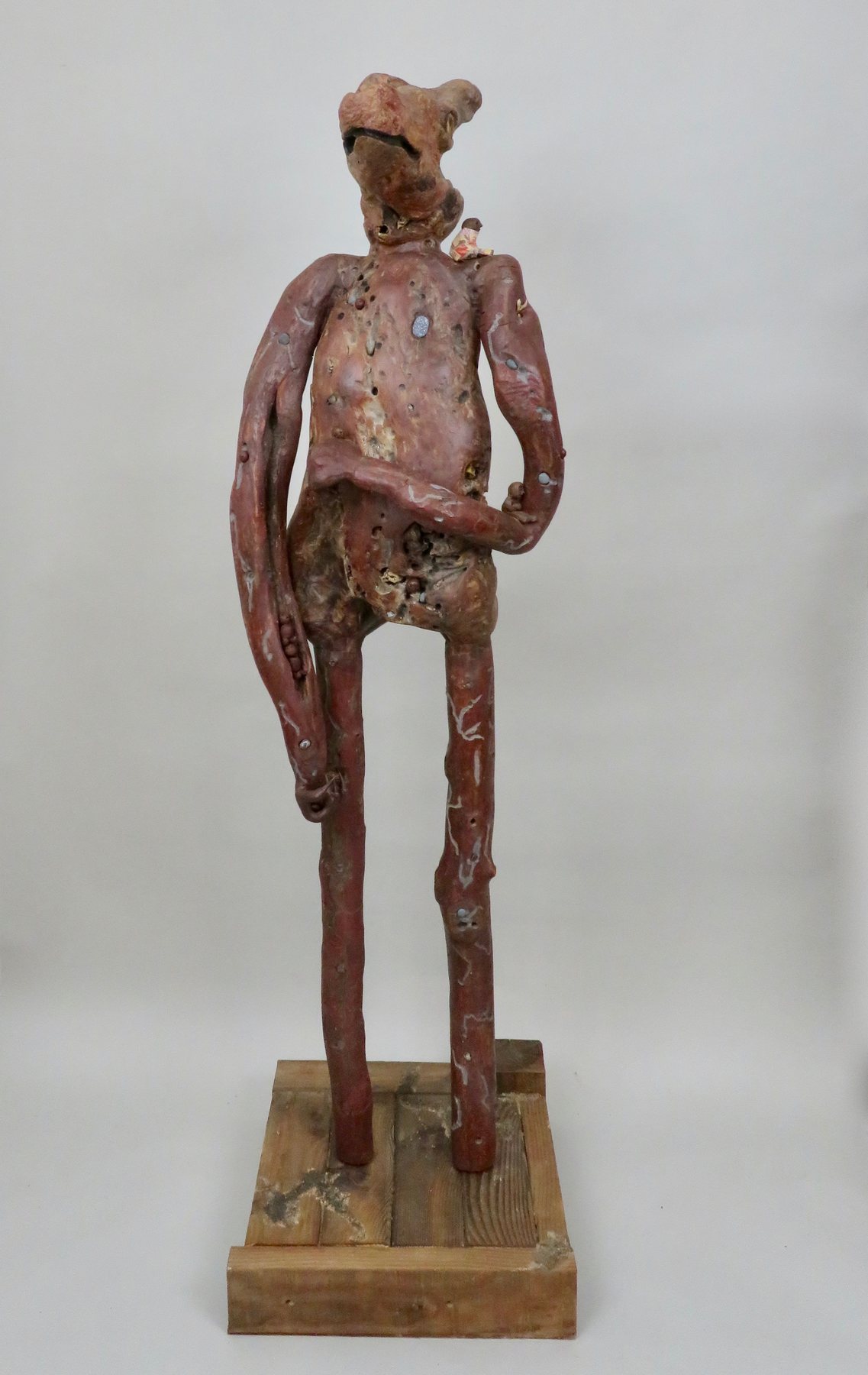 A guardian in weathered driftwood, arms at its sides