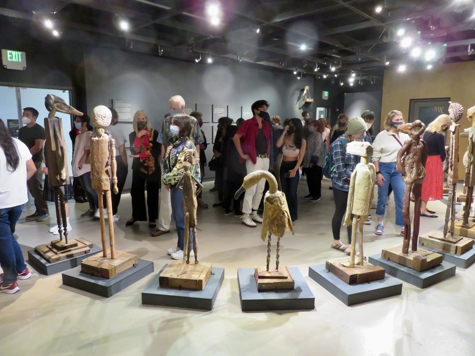 Visitors moving among the standing figures