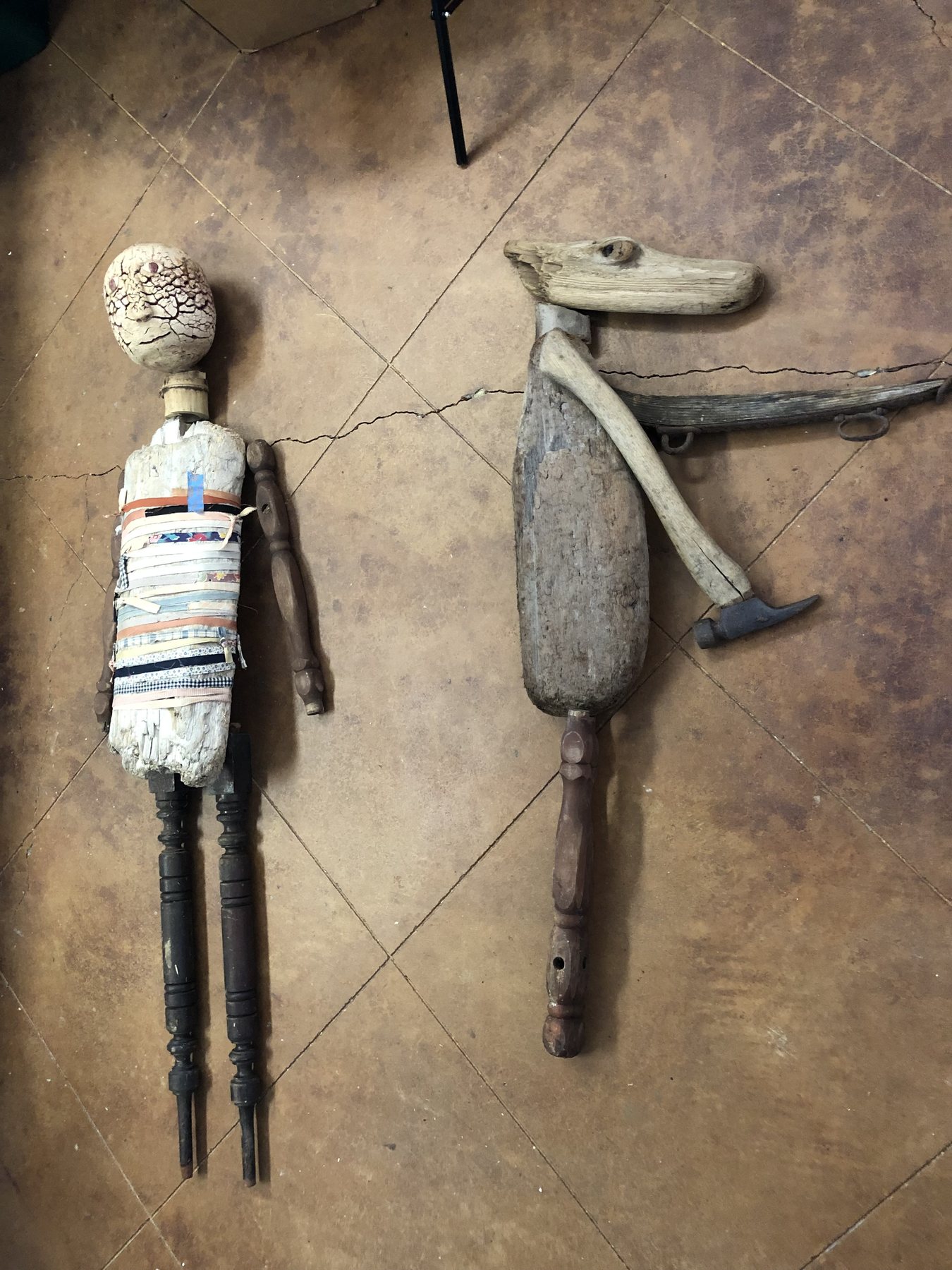 Two guardian figures under construction
