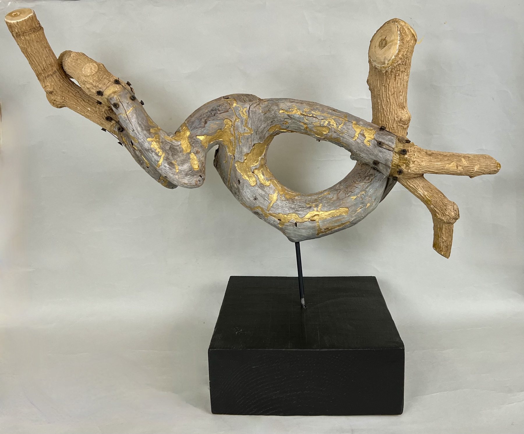 Jack Rabbit, beetle-inscribed wood and bark on a black plinth