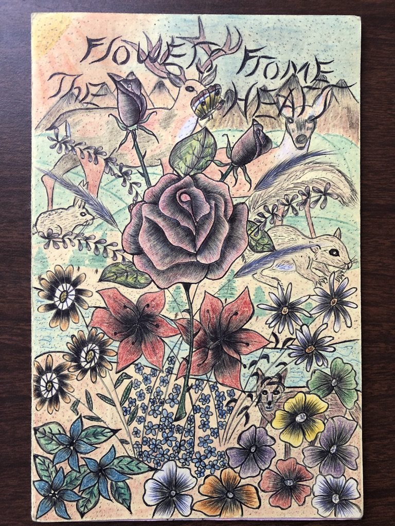 Framed drawing by a workshop member: "Flowers From The Heart" hand-lettered across the top, with a large rose surrounded by smaller flowers, birds and insects.