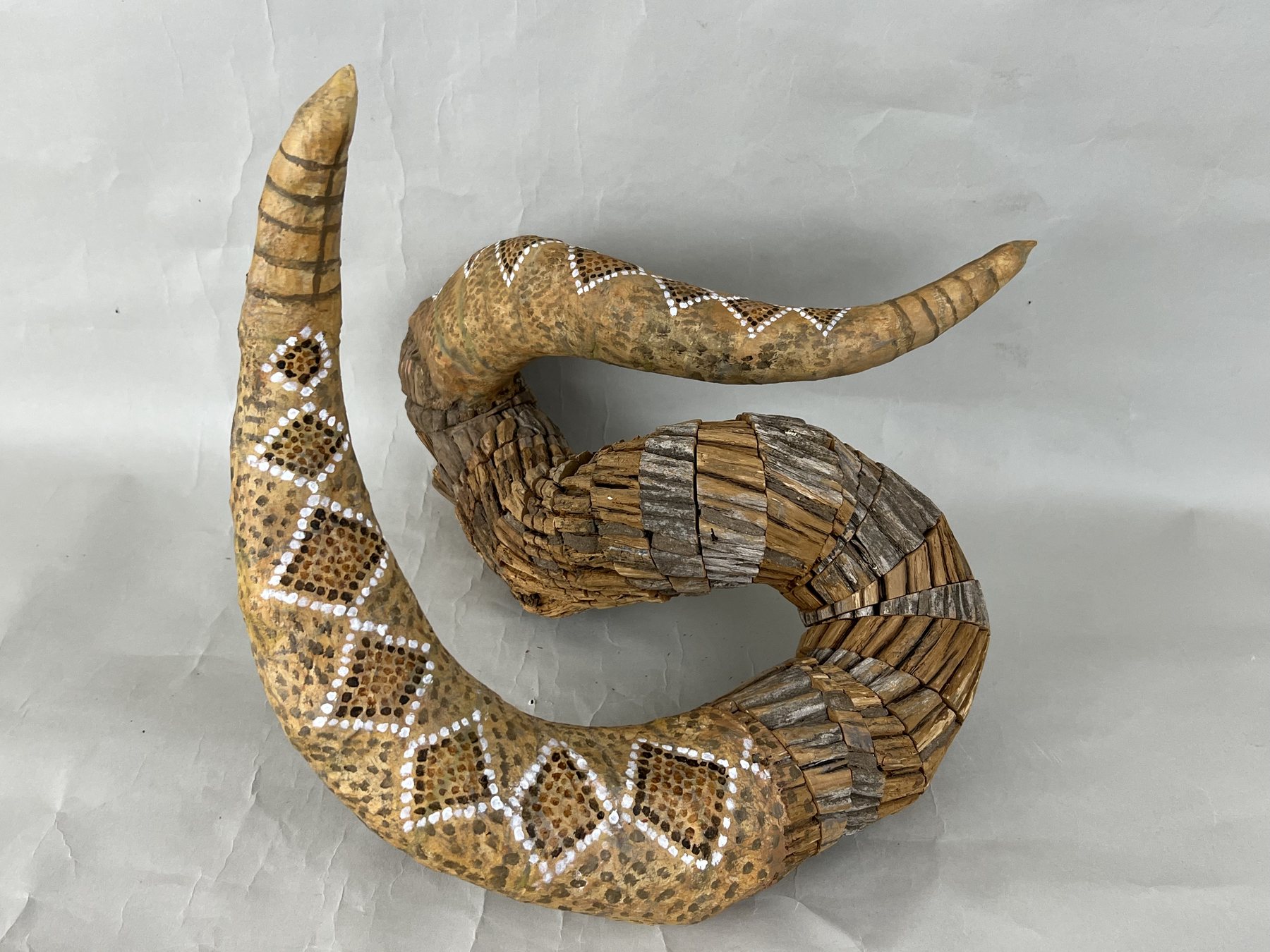 Rattler, weathered Colorado wood and papier-mache with a patterned skin