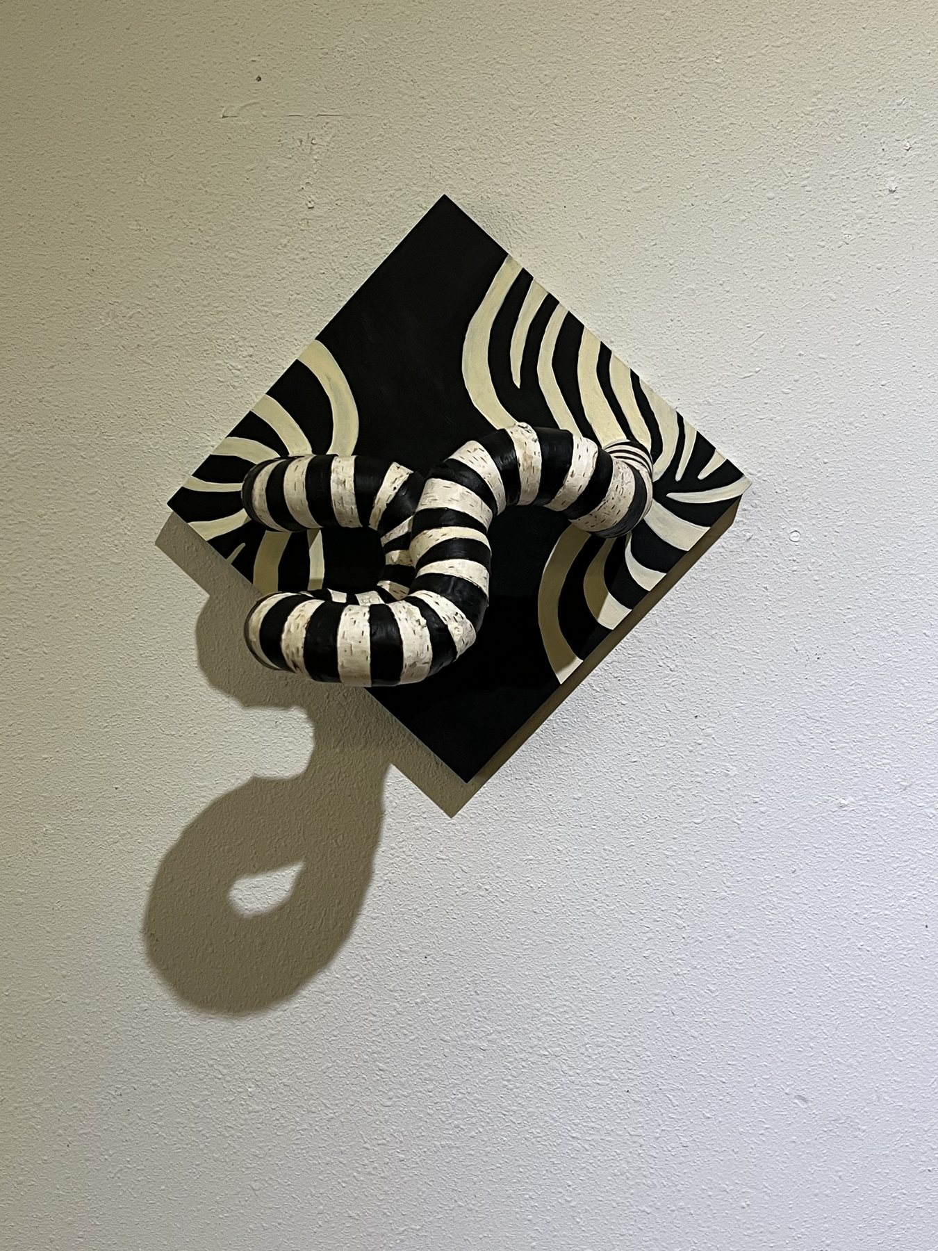 Zebra, altered birch wood painted in black and white stripes, hung as a diamond