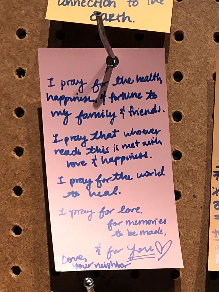 A visitor's message on a pink card: I pray for the health, happiness and fortune of my family and friends