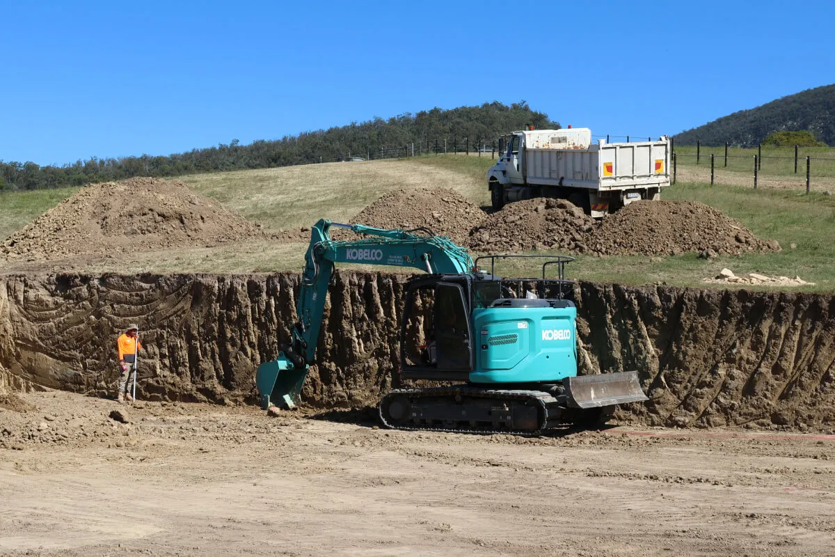 Bulk Earthworks service in Brisbane. Pad cutting & grading using excavators. Site preparation ready for infrastructure development