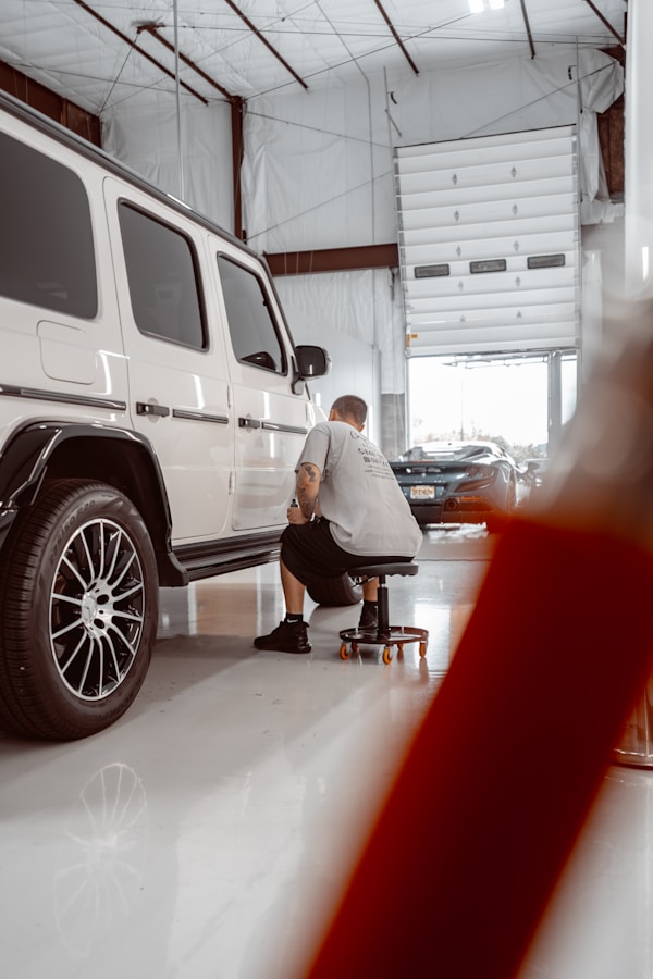 Vehicle project being reviewed inside the PCB Wraps installation shop