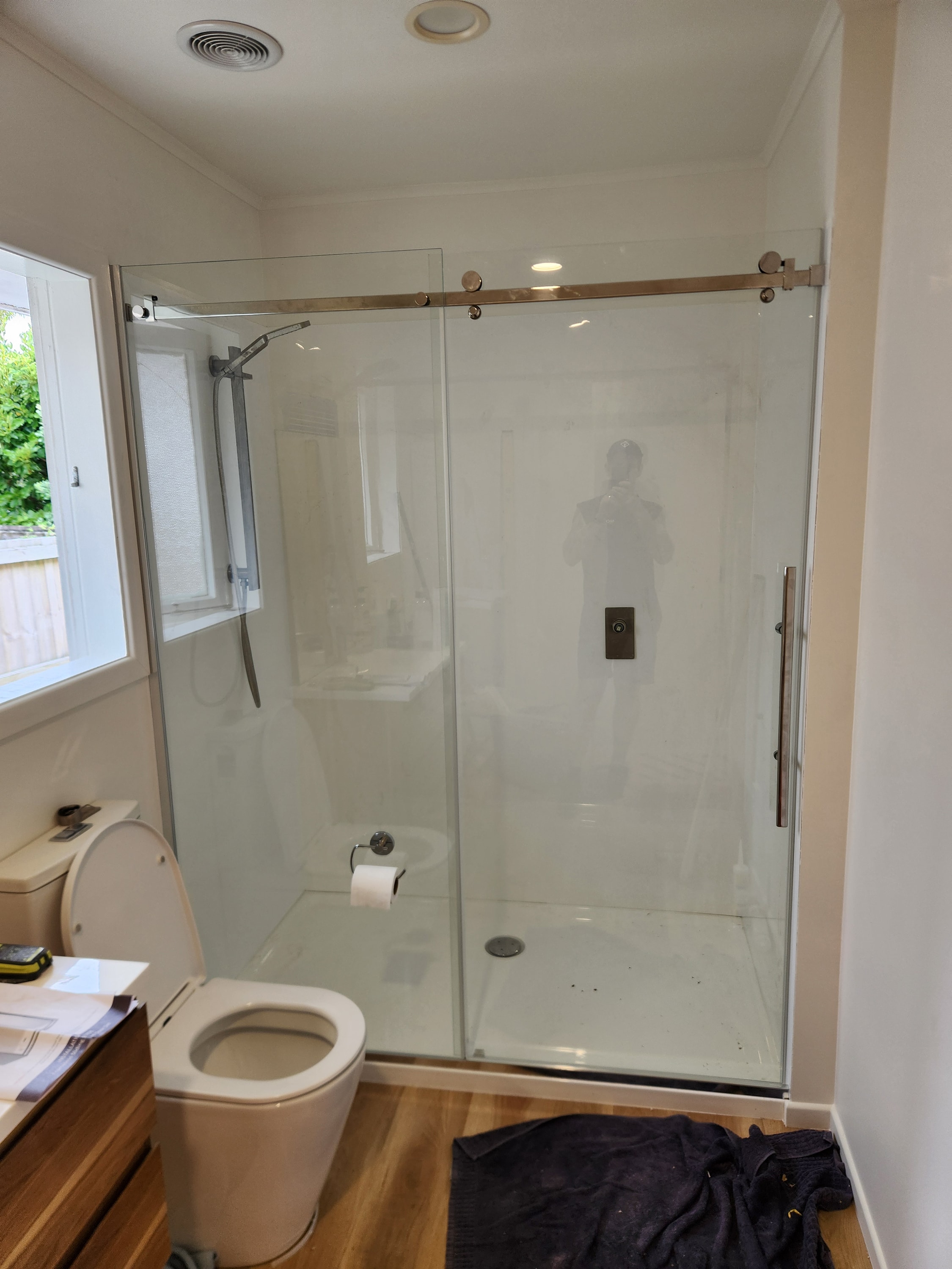 Completed bathroom renovation with tiled walk-in shower