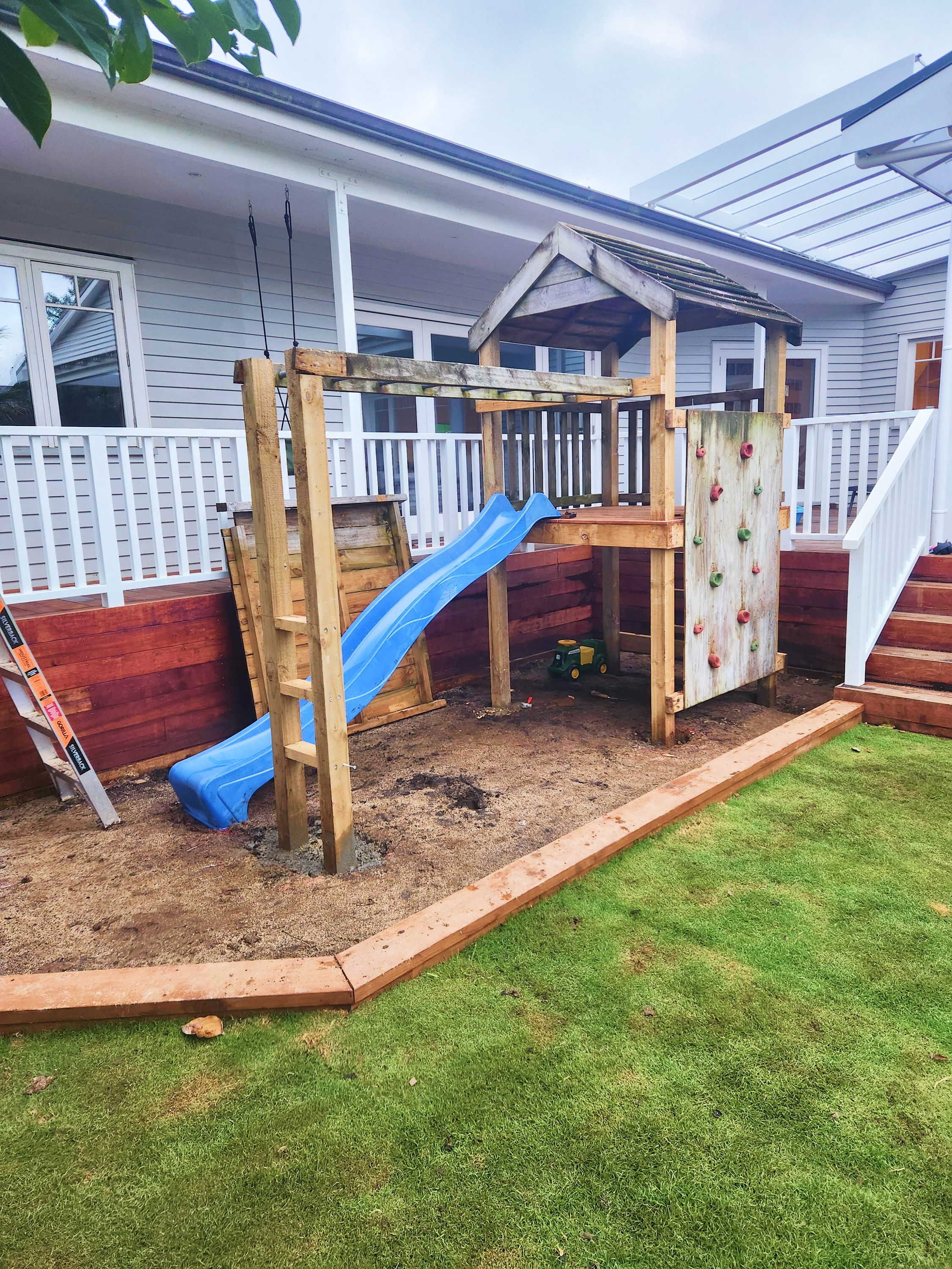 Custom timber playground and garden edging in an Auckland backyard