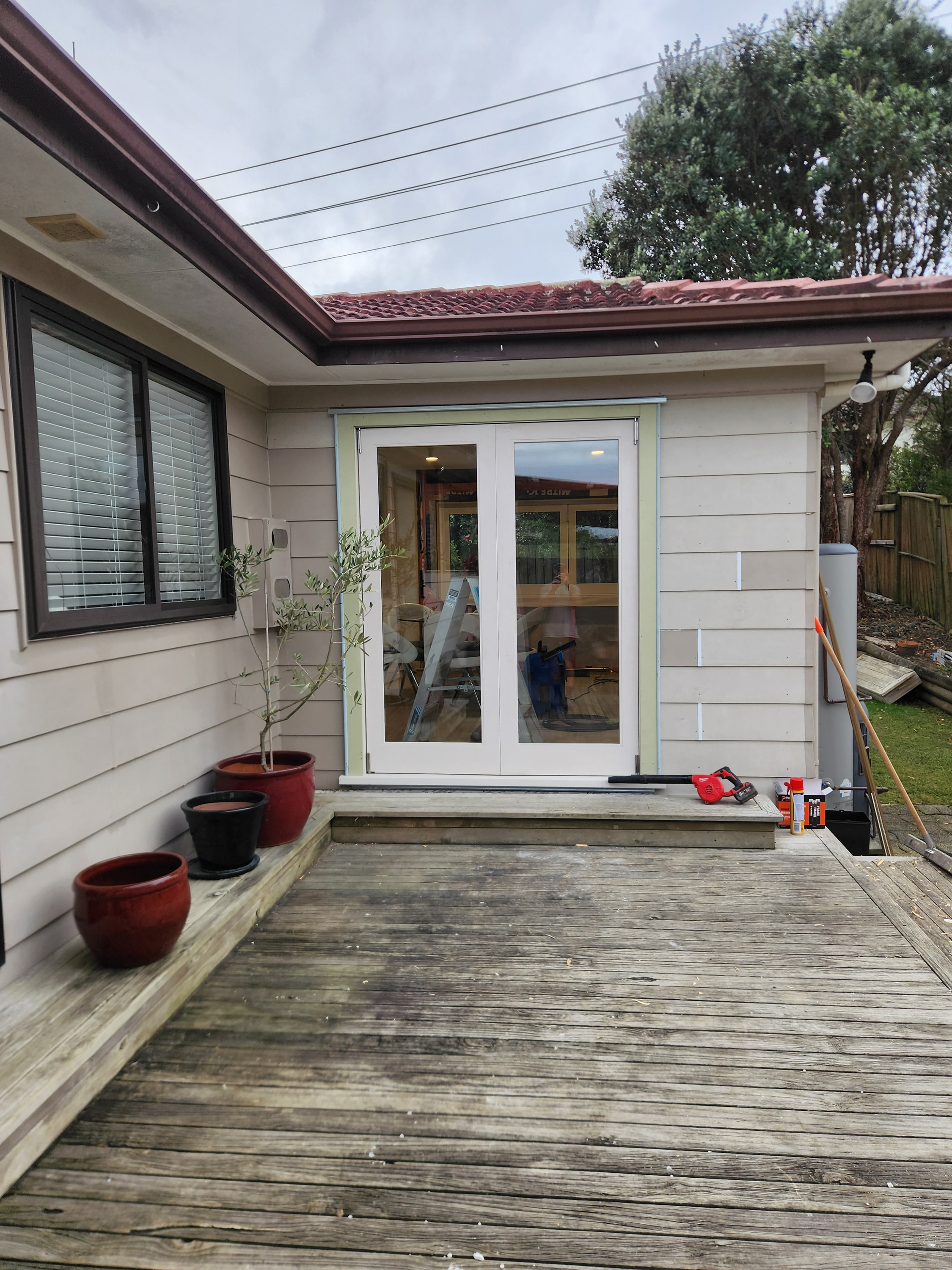 French doors opening onto a rebuilt timber deck