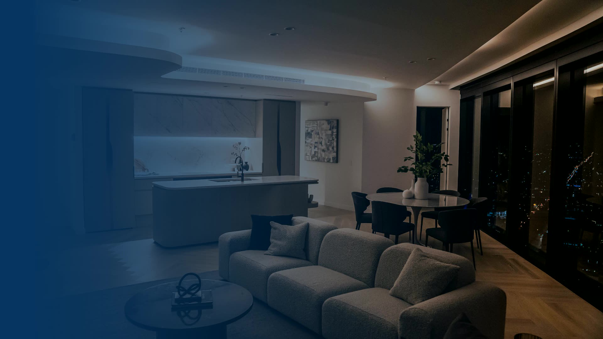 Furnished apartment living room at night with city view